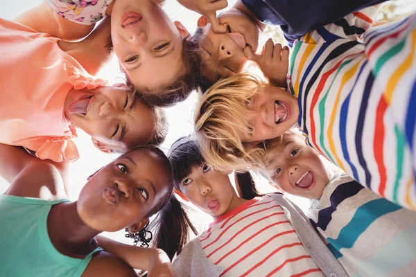 Schoolkids forming huddle — Stock Photo, Image