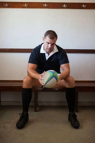 Rugby player looking at ball — Stock Photo, Image