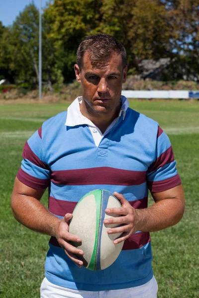 Jogador de rugby de pé com bola — Fotografia de Stock