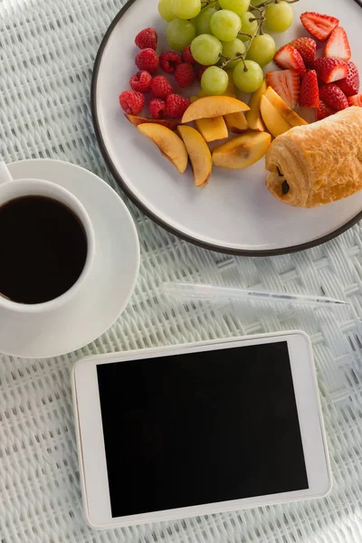 Cyfrowego tabletu przez filiżanki kawy i owoce — Zdjęcie stockowe