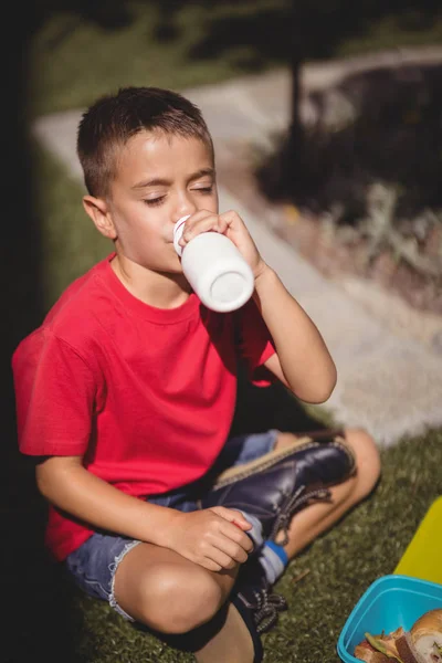 Okul bahçesinde suyu içme öğrenci — Stok fotoğraf