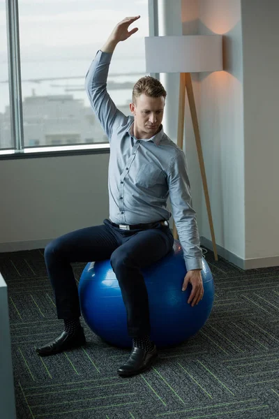 Executive performing stretching exercise — Stock Photo, Image