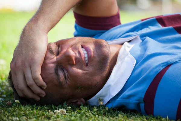 Jogador de rugby ferido deitado em campo — Fotografia de Stock