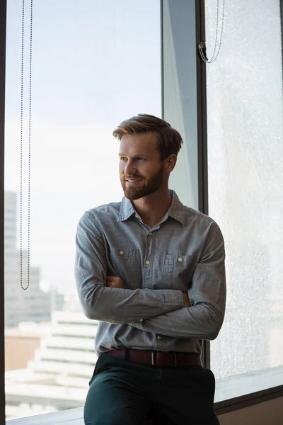 Male executive sitting with arms crossed — Stock Photo, Image