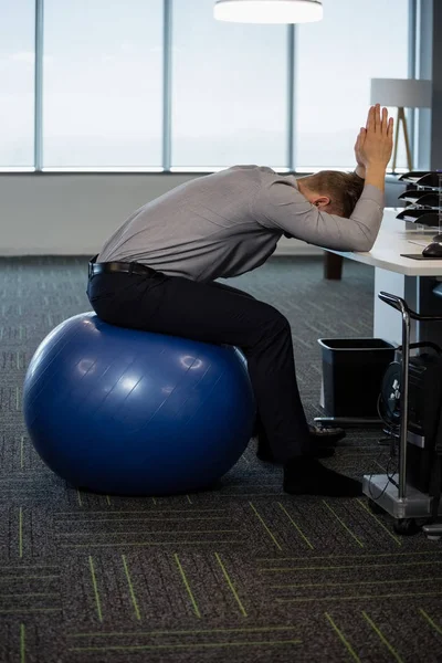 Executive exercising on fitness ball — Stock Photo, Image