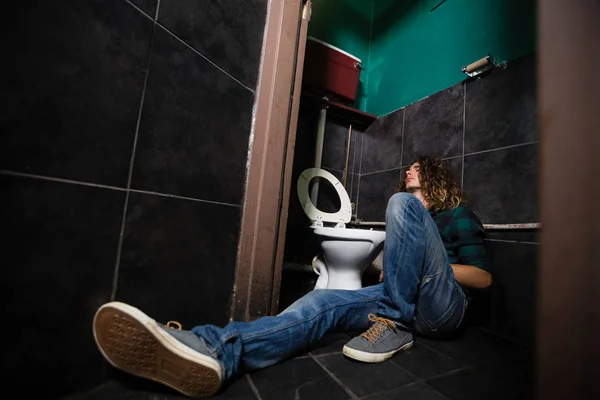 Man sleeping in the washroom — Stock Photo, Image
