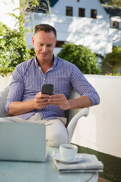 Человек с телефоном, сидя в кафе — стоковое фото