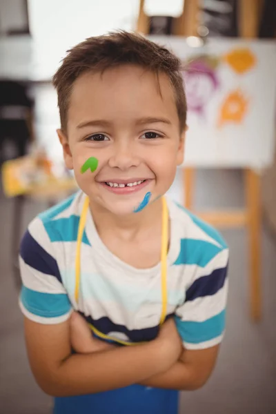 Schoolboy with paint on face — Stock Photo, Image