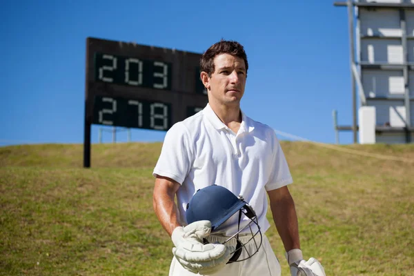 Cricket player holding helmet — Stock Photo, Image
