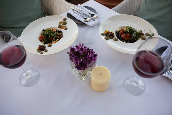 Food and drinks served on decorated table — Stock Photo, Image