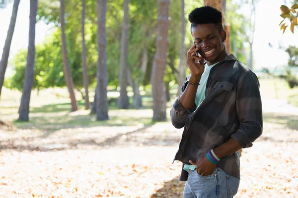 Man talking on phone in park — Stock Photo, Image