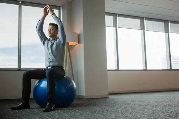 Ügyvezető elmélkedve fitness labda — Stock Fotó