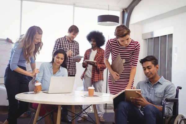 Handicap businessman discussing with team — Stock Photo, Image