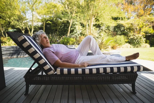 Senior woman resting on lounge chair — Stock Photo, Image