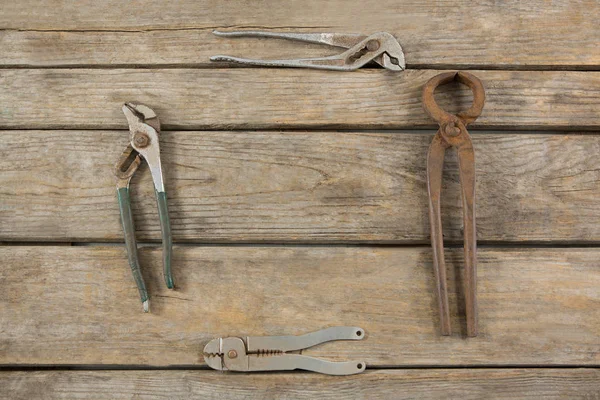 Rusty tools arranged on wooden table — Stock Photo, Image