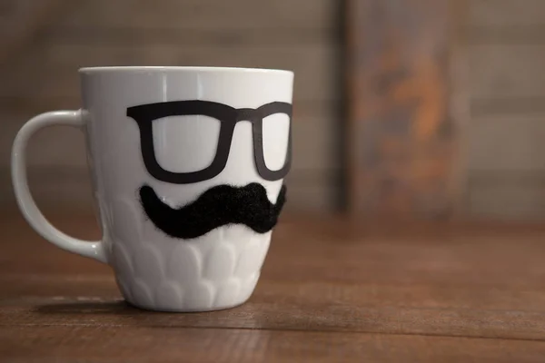 Fake moustache and spectacles on mug — Stock Photo, Image
