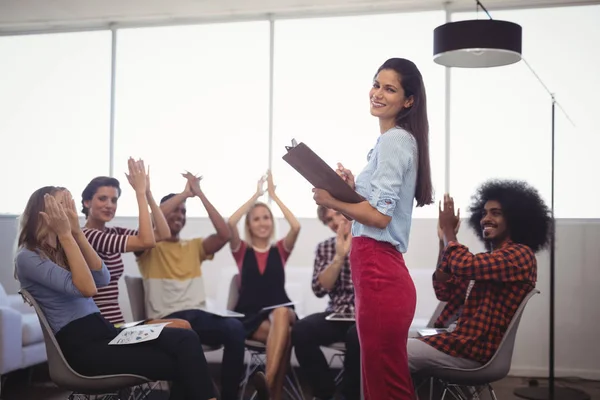 Colleagues applauding for businesswoman — Stock Photo, Image