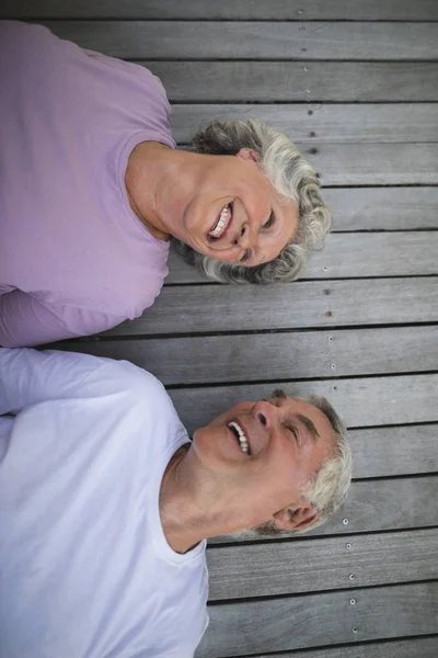 Äldre par liggande på trägolv — Stockfoto