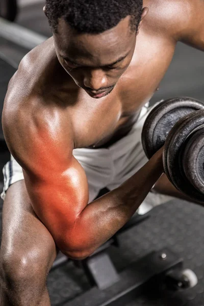 Man doing excercise with dumbbell — стоковое фото