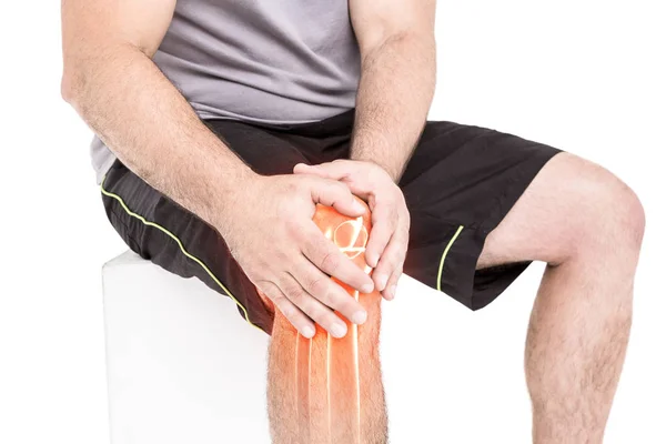 Man holding sore knee — Stock Photo, Image