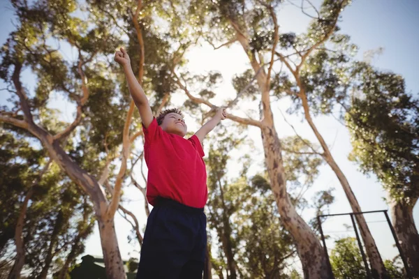 Boy cheering during obstacle course — Stock Photo, Image