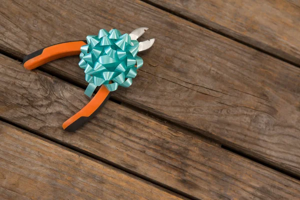 Pliers decorated with ribbon — Stock Photo, Image