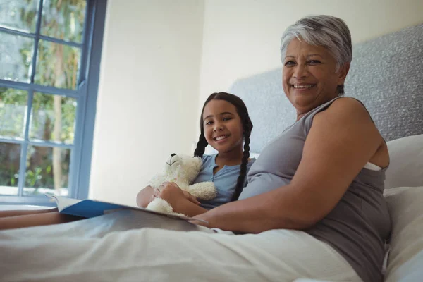 Abuela y nieta sosteniendo álbum de fotos — Foto de Stock