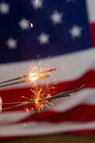 Espumantes a arder contra a bandeira americana — Fotografia de Stock