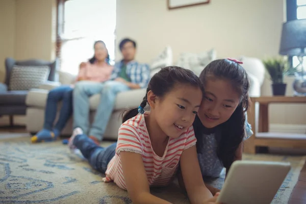 Broers en zussen met behulp van digitale tablet in woonkamer — Stockfoto