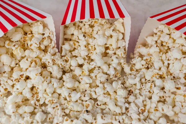 Scattered popcorn on wooden table — Stock Photo, Image