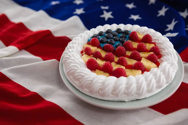 Fruitcake served in plate on American flag — Stock Photo, Image