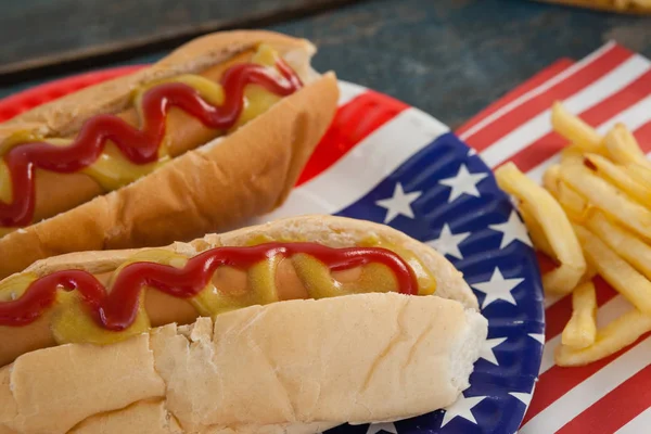 Hot dogs served on plate with french fries — Stock Photo, Image