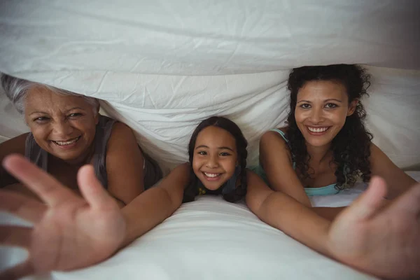 Famiglia sdraiata sul letto in camera da letto — Foto Stock