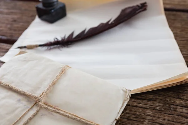 Quill feather, ink pot, and legal documents — Stock Photo, Image