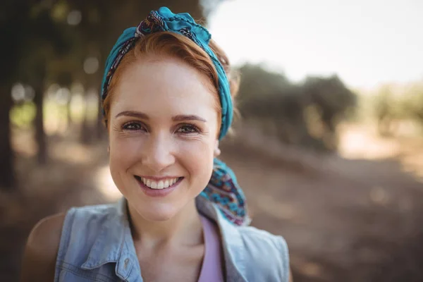 Smiling young woman at olive farm — Stock Photo, Image