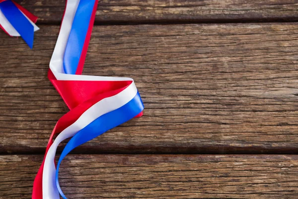 Red, white and blue ribbon arranged on table — Stock Photo, Image