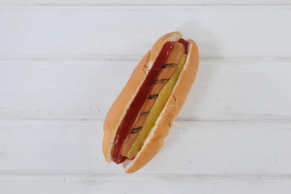 Perro caliente sobre mesa de madera — Foto de Stock