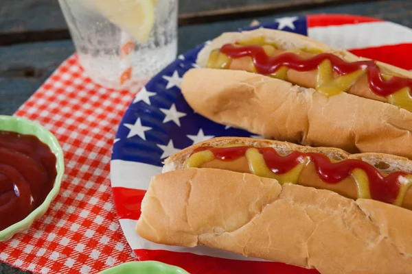 Hot dogs served in plate on table Stock Photo