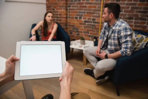 Executive using tablet and colleagues discussing — Stock Photo, Image