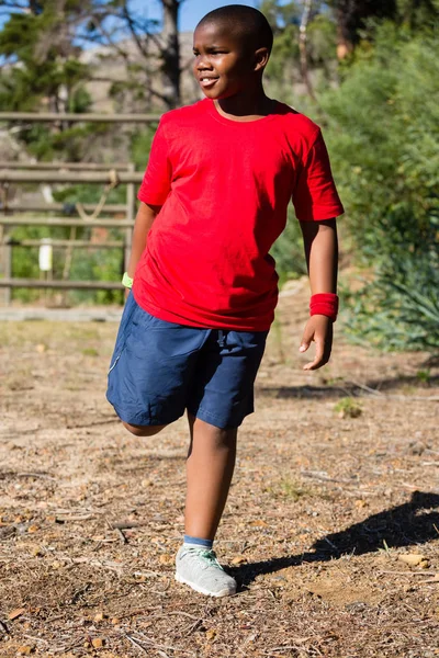 Boy performing stretching exercise — Stock Photo, Image