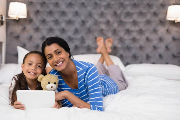 mother and daughter using tablet