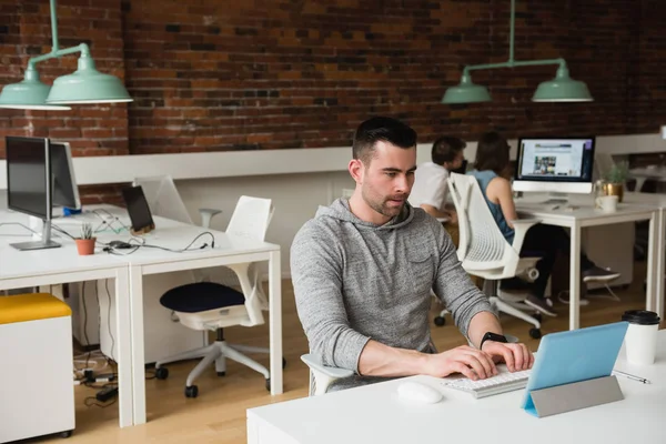 Male executive using digital tablet at desk — Stock Photo, Image