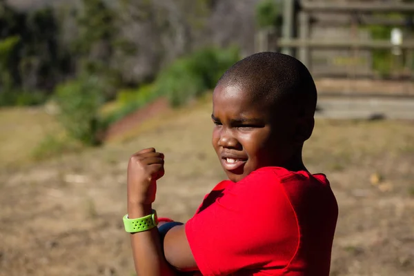 Boy performing stretching exercise — Stock Photo, Image