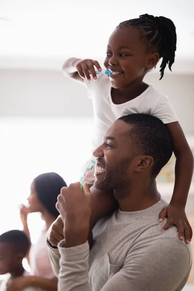 Family brushing teeth in bathroom — Stock Photo, Image