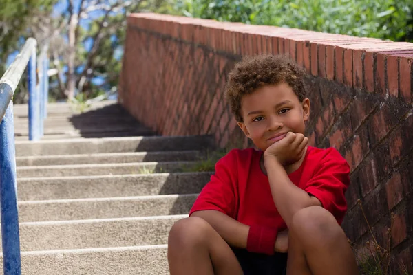 Boy sitting on staircase in the boot camp — Stock Photo, Image