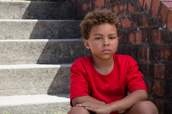 Upset boy on staircase in boot camp — Stock Photo, Image