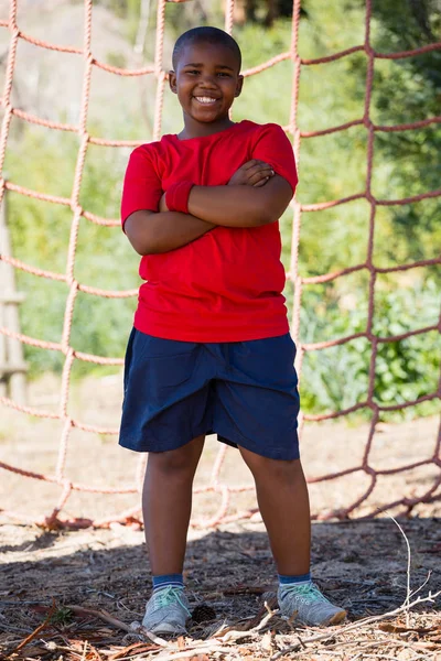 Boy standing with arms crossed — Stock Photo, Image