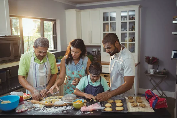 family preparing dessert in kitchen