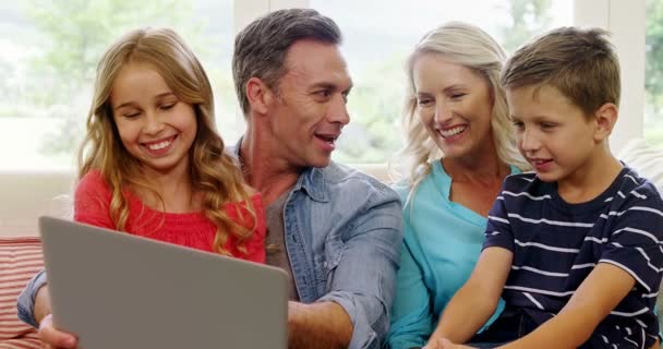 Family using laptop in living room — Stock Video