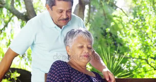 Senior couple kissing each other in garden — Stock Video